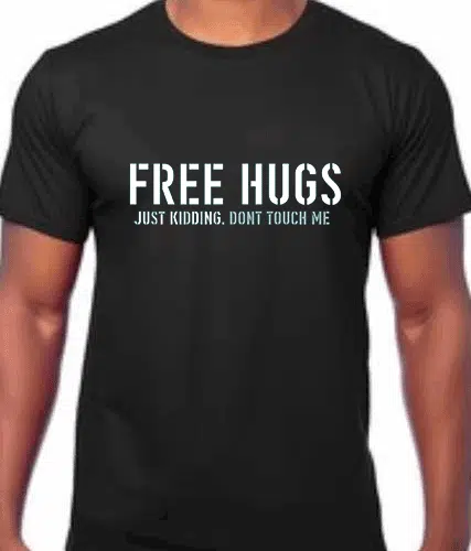 image of Black t shirt with slogan "FREE HUGS JUST KIDDING DONT TOUCH ME printed on the front in white