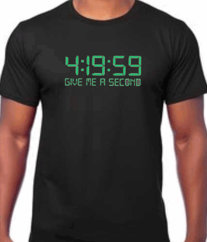 Image of a black t-shirt with the phrase '4:20 Cannabis Culture T-shirt' prominently displayed. The slogan '4:19:59 give me a second' is featured below the main text. The design evokes the essence of cannabis culture and its associated time reference.
